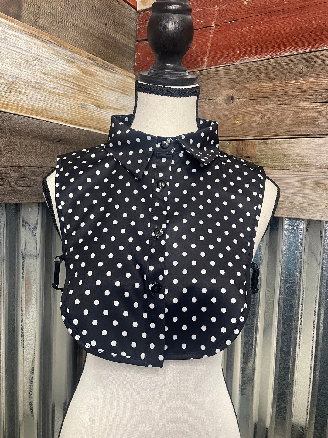 Black polka dot umbrella on a wooden surface