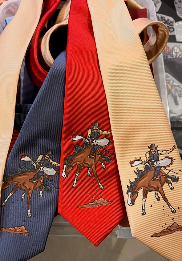 Three neckties with cowboy designs