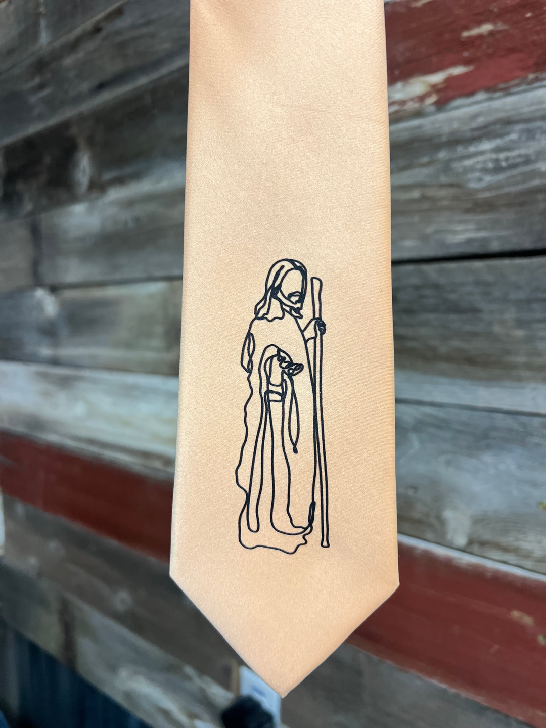 Hexagonal wooden stamp with a black line drawing of a figure on a wooden background
