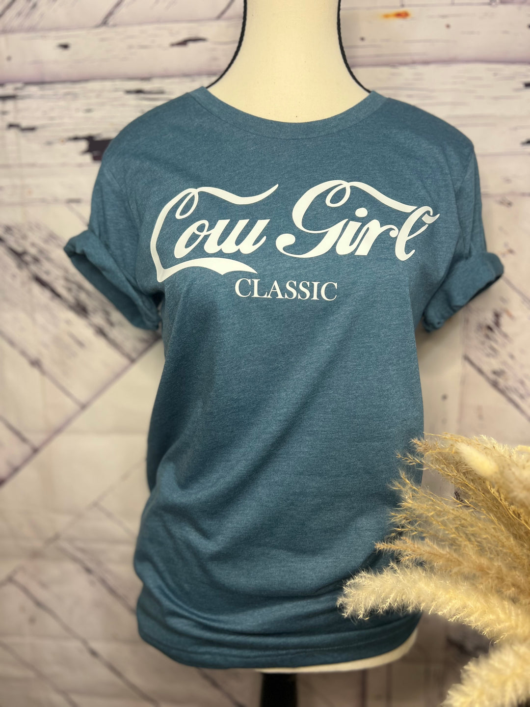 A person wearing a blue graphic tee with &