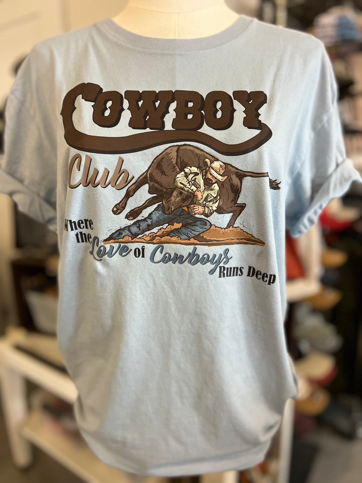 Light blue t-shirt with cowboy graphic and text on a mannequin.