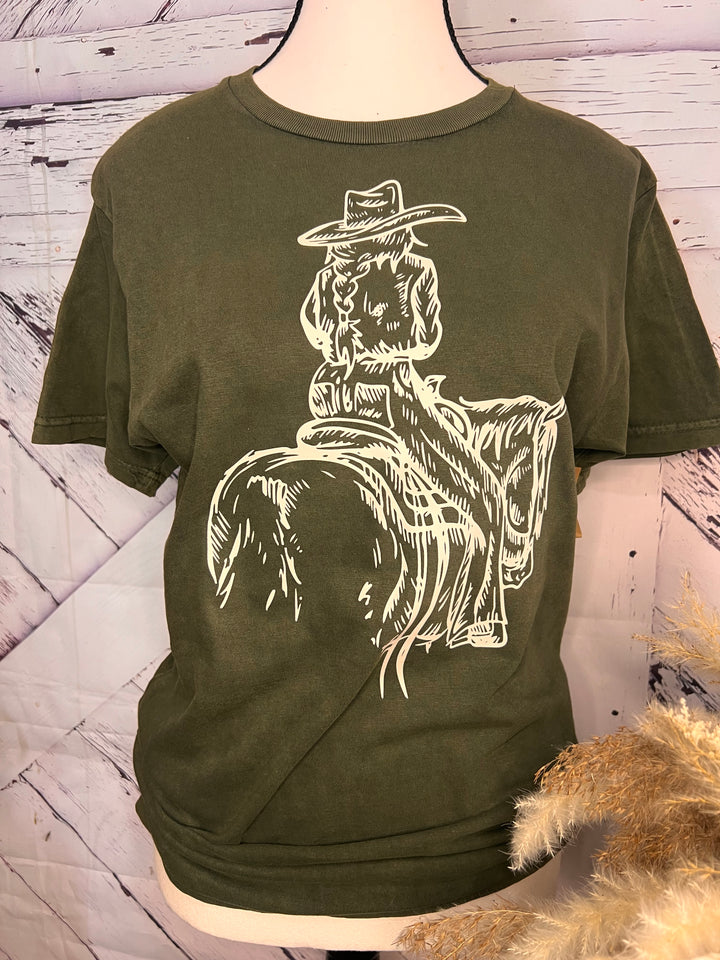 A green t-shirt with a white print of a cowgirl riding a horse.