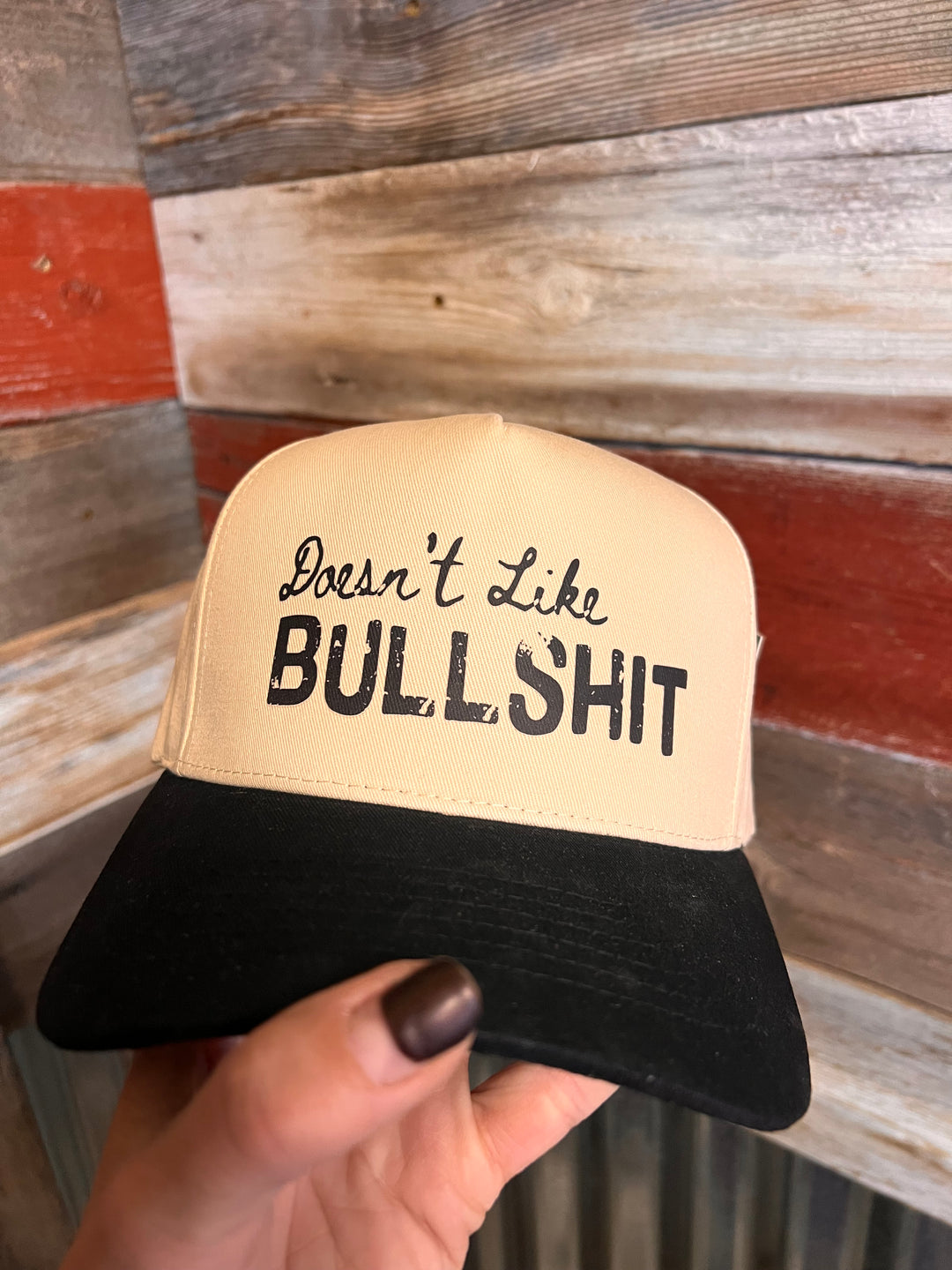 Hand holding a product with text against a wooden background
