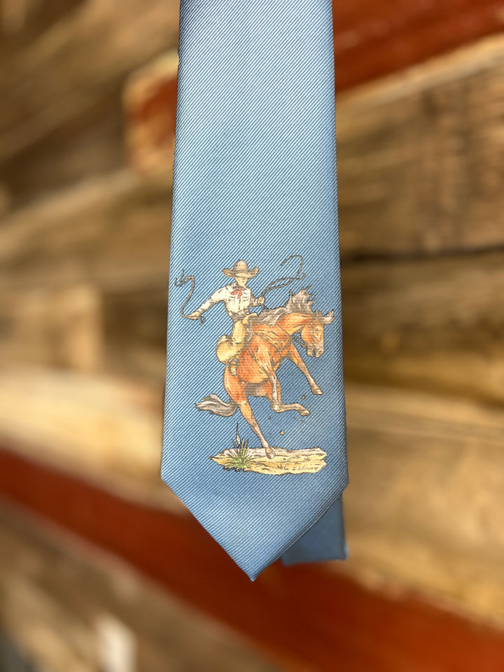 Light blue tie with a cowboy and horse design on a wooden surface