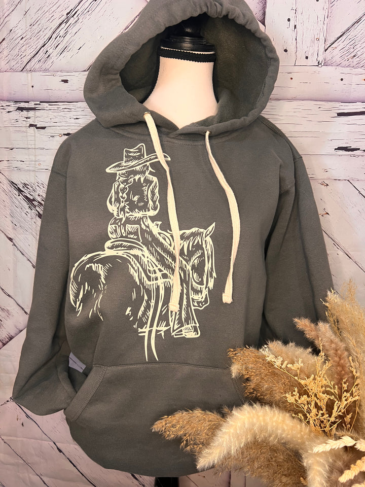 A gray hoodie featuring a printed design of a cowgirl riding a horse, displayed on a mannequin.