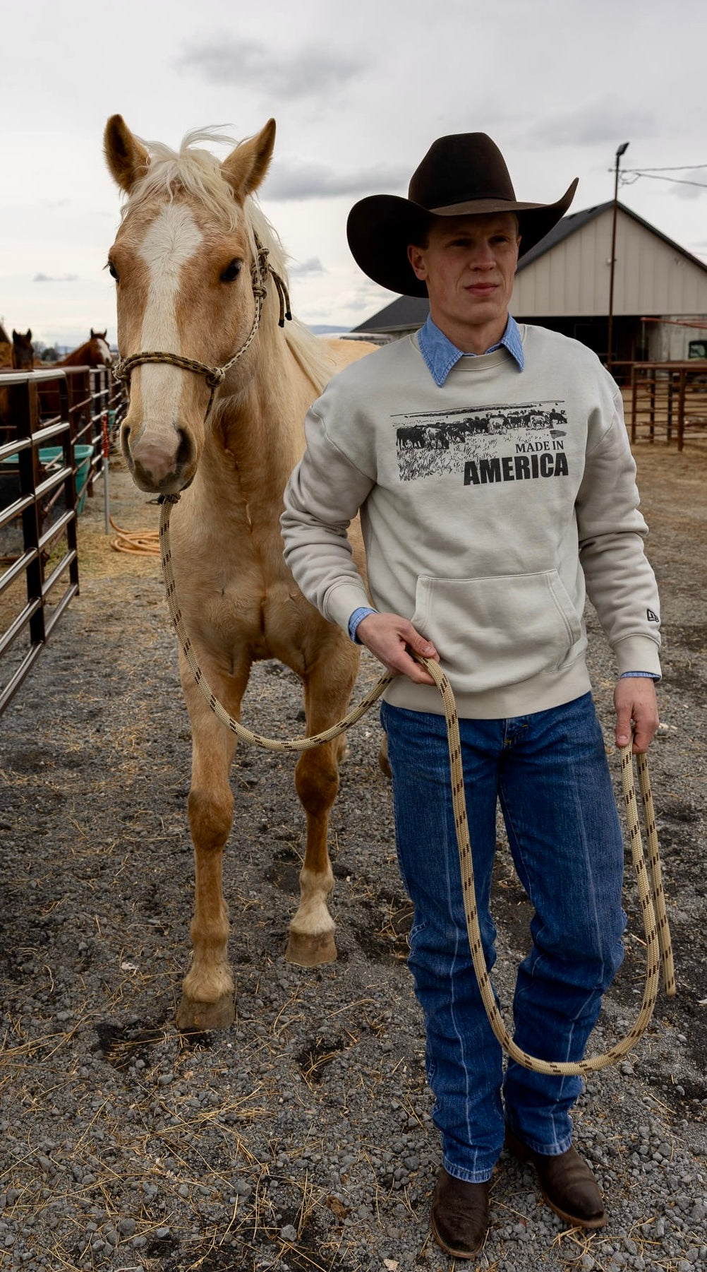 Man in cowboy hat leading a horse in an outdoor setting