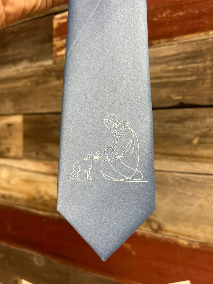 Gray tie with a white abstract design against a wooden background