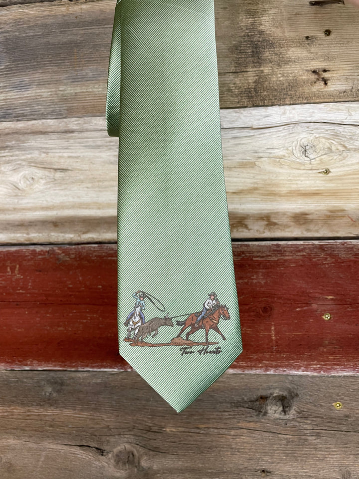 Green tie with a embroidered design on a wooden background