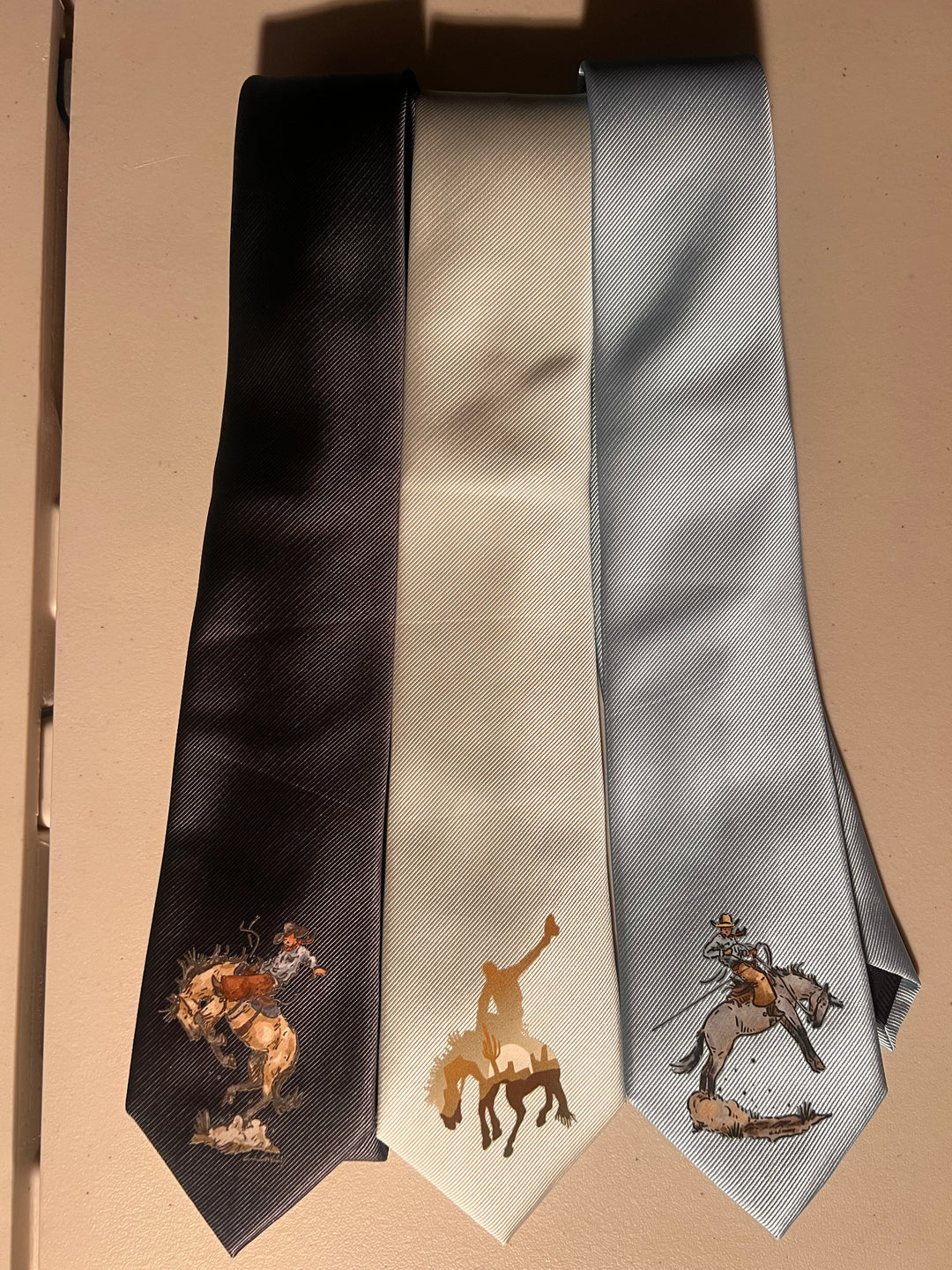Three neckties with printed designs