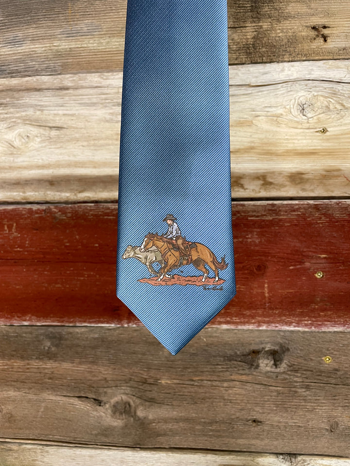 Blue tie with an embroidered design on a wooden surface