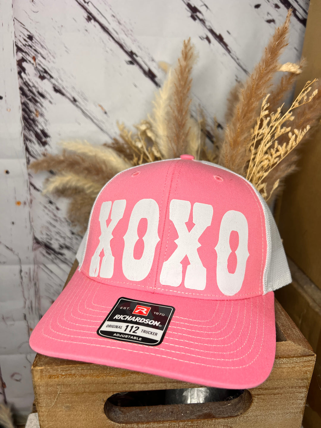 A pink Richardson 112 trucker cap with white mesh back and &