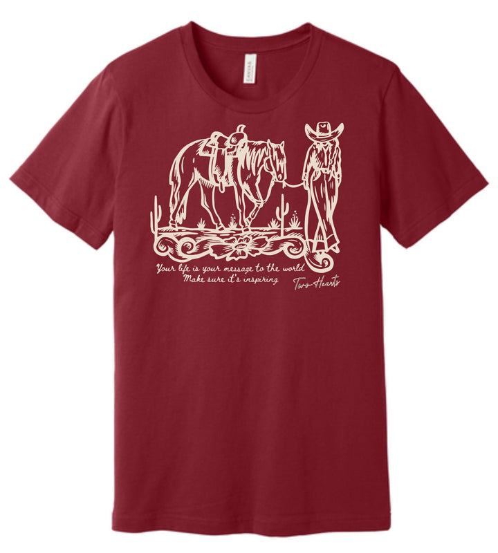 Maroon t-shirt with white graphic of a cowboy and horse, and text on a white background