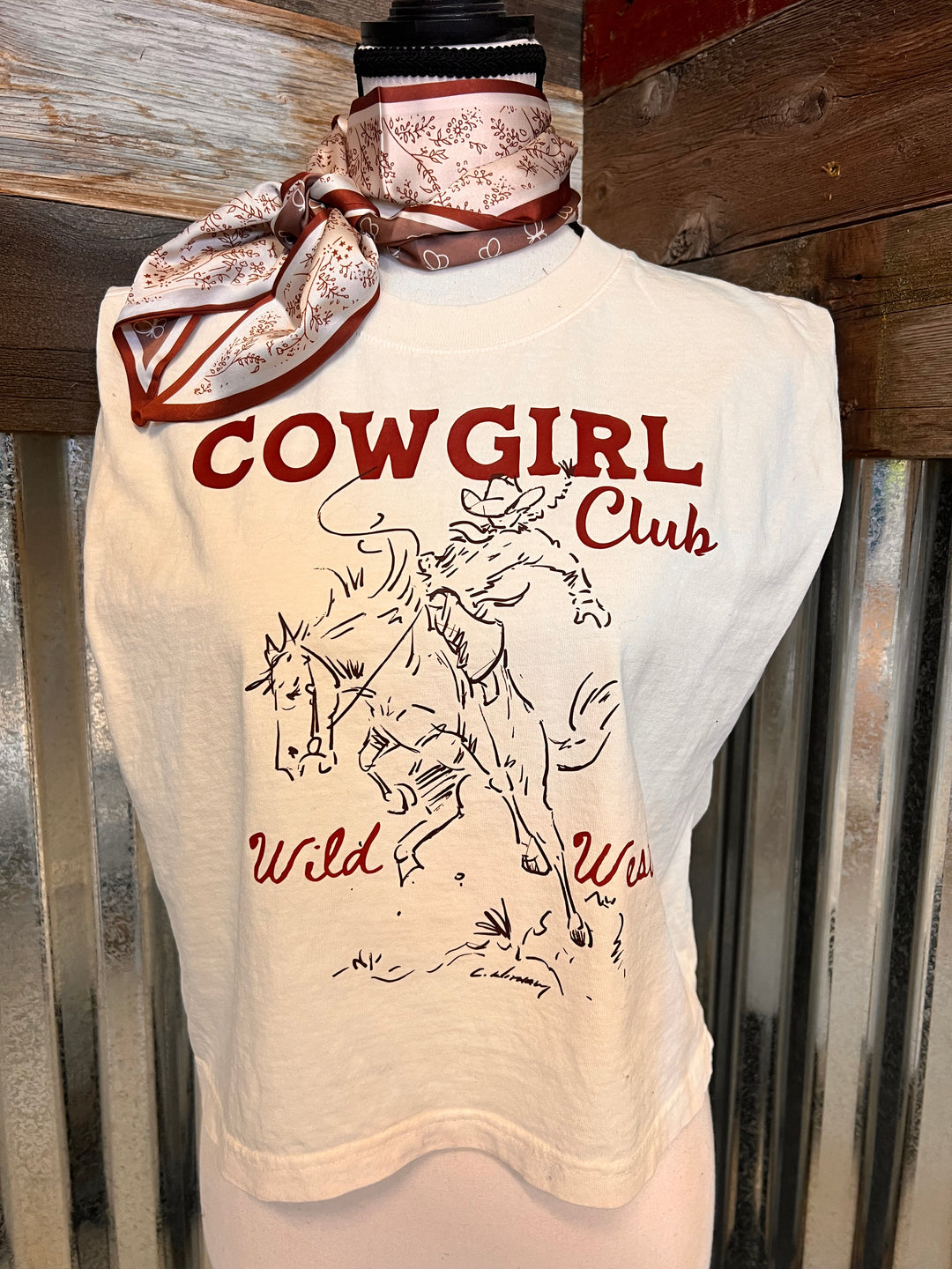 'Cowgirl Club' text and graphics on a metal surface