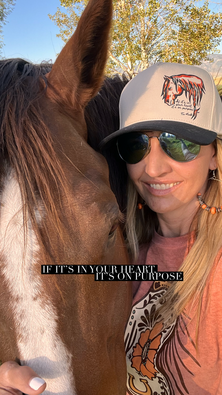 Woman wearing a cap and sunglasses, standing next to a horse with a quote on the image.