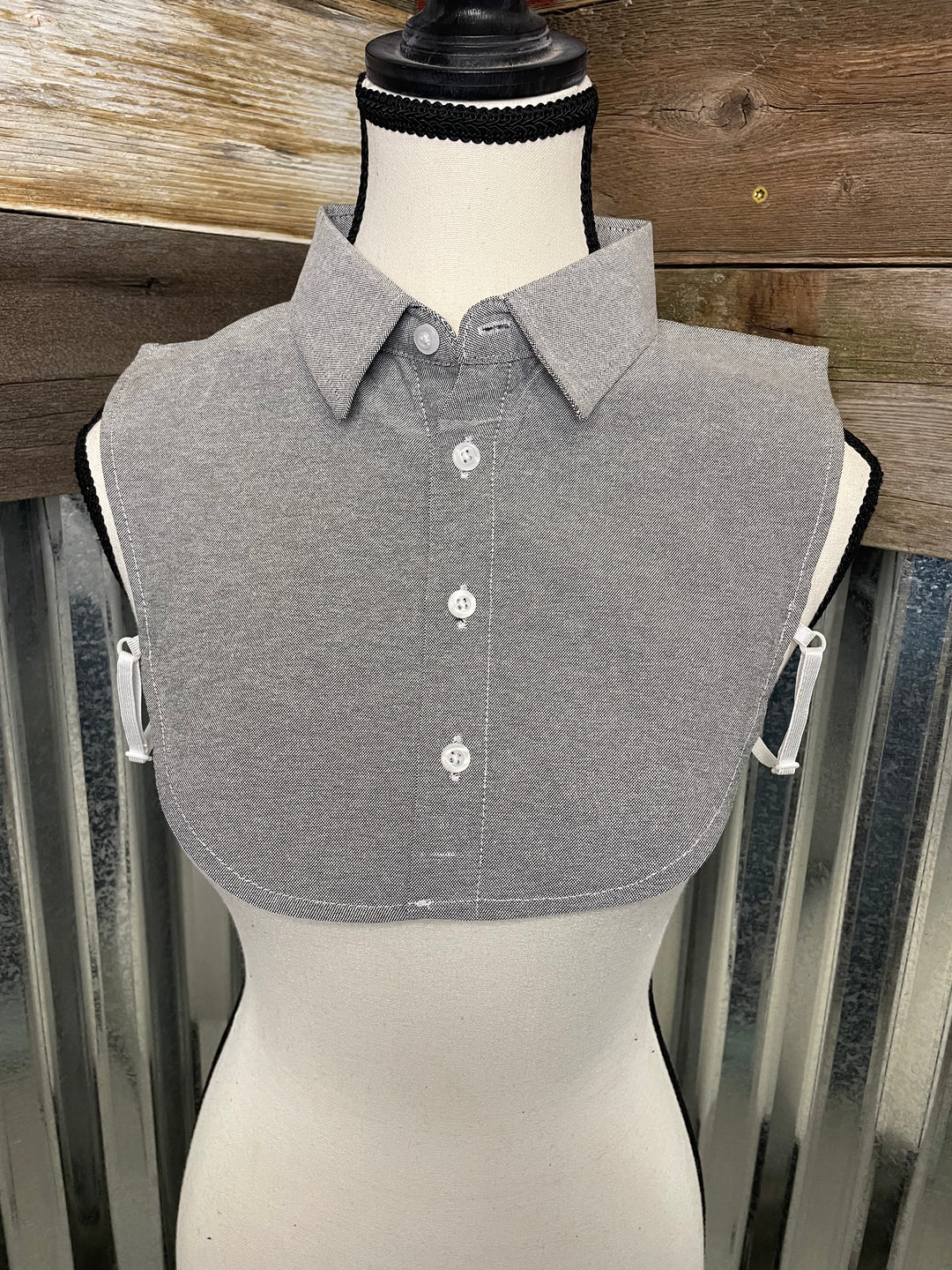 Gray shirt on a mannequin against a wooden background