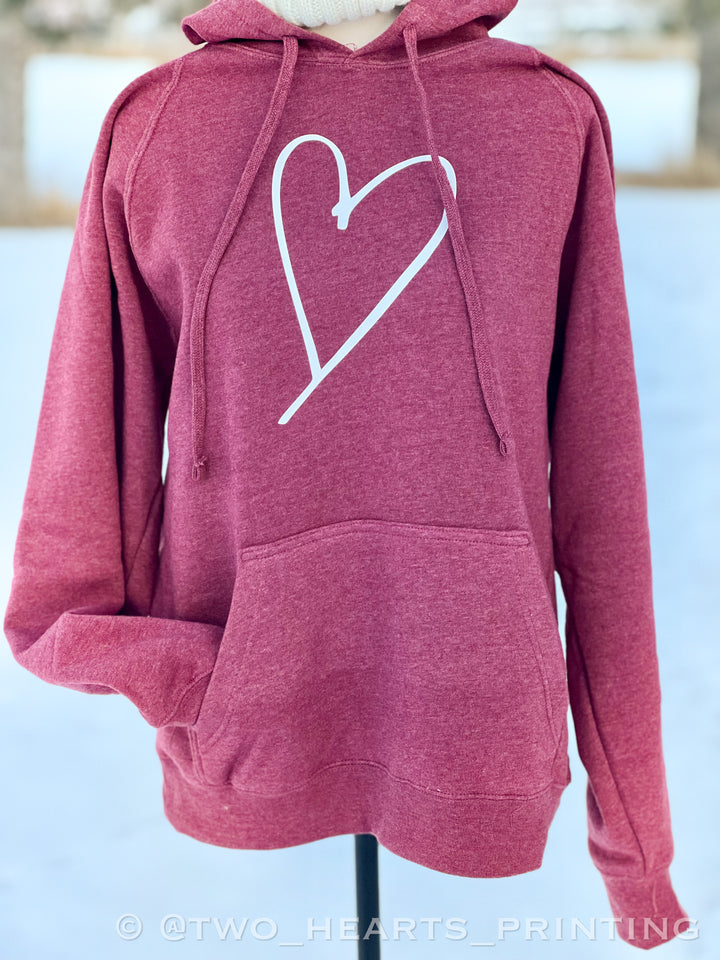 A red heather color hoodie with a white heart graphic on the front.